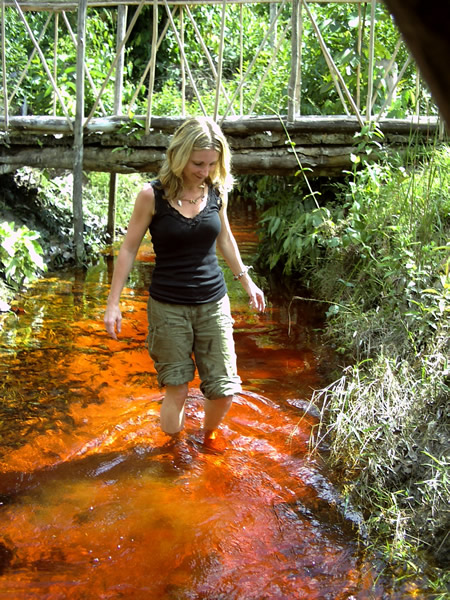 Woman wading in stream