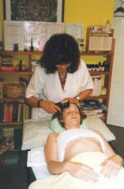 Therapist Gillian Barker using the SCENAR device. The device locates an area requiring treatment and creates the necessary bioenergetic feedback