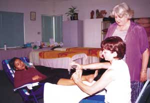 Lynn Hatswell supervising a reflexology student practitioner