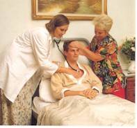 Geraldine McHugh (co-founder) and our Doctor, Liza Jackson, giving Reiki to a patient whilst monitoring the heartbeat.