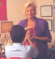 Carole Easton demonstrates one of the hand positions used during an initiation/attunement.