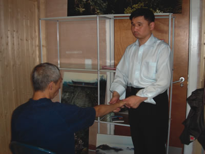 Zhu Gang, the Vice-Chairman of China Massage Association of Blind Practitioners massaging a client