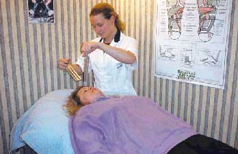 Tuning forks being used by a practitioner during a Sound therapy treatment. In this case several forks are being used to treat the Heart Chakra or Plexus point in an active rolling movement over the area