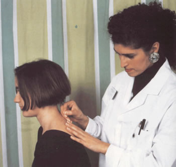 A nurse applying acupuncture to a patient.