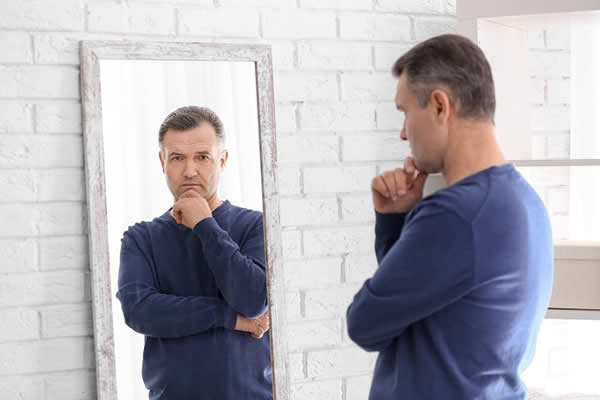 Man thinking in mirror