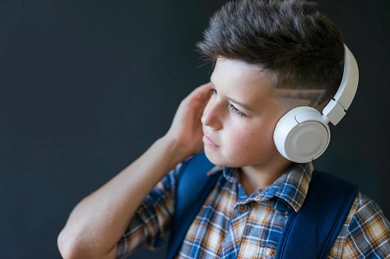A Boy Wearing Wireless Headphones