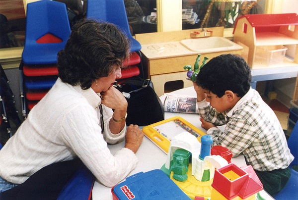 A special education teacher assists one of her students